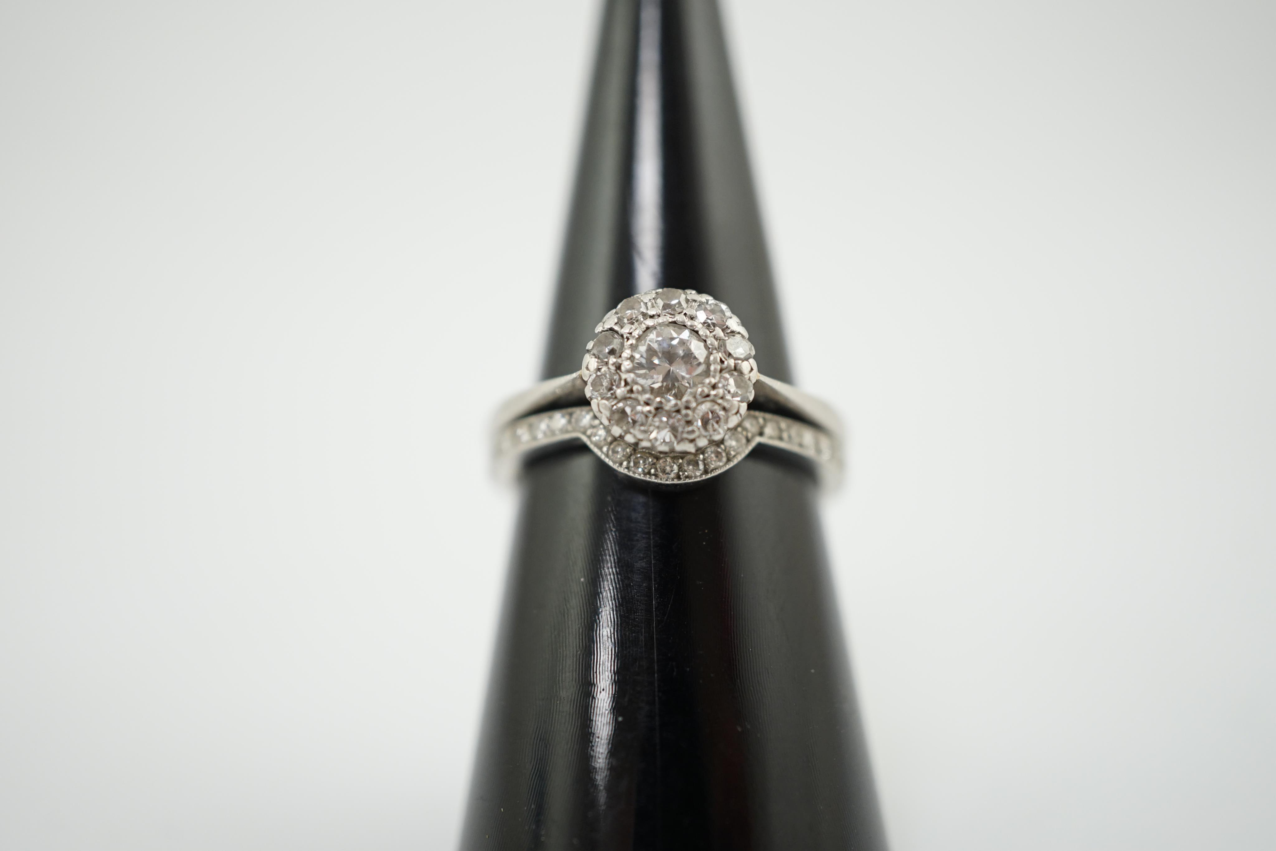 A mid 20th century and later platinum and diamond matched two piece wedding set